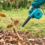 TOTAL handheld electric blower with black nozzle and dust collection bag clearing dust and debris from a concrete surfacetoolstationpakistan, toolstation.com