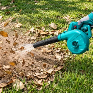 TOTAL handheld electric blower with black nozzle and dust collection bag clearing dust and debris from a concrete surfacetoolstationpakistan, toolstation.com