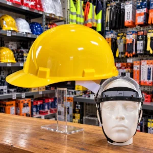 Yellow safety hard hats stacked on a wooden table at a construction workplacetoolstationpakistan, toolstation.com