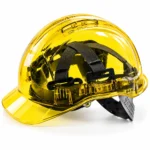 Yellow safety hard hats stacked on a wooden table at a construction workplacetoolstationpakistan, toolstation.com