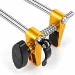 Adjustable gold alloy door mortising and drilling jig mounted on a wooden door with steel guide rods, clamps and cutter bits. toolstationpakistan, toolstation.com